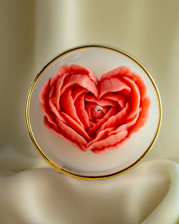 a candle with Heart-shaped rose design on a white background with a gold rim by lila with love