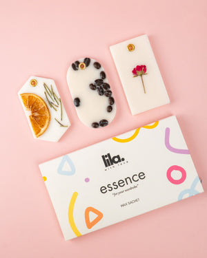 Lila essence wax sachets  packaging with floral and fruit designs on a pink background